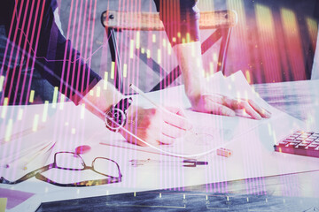 Multi exposure of man standing and planing investment with stock market forex chart.