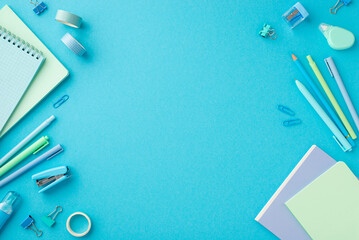 Back to school concept. Top view photo of blue stationery notepads adhesive tape binder clips pens...