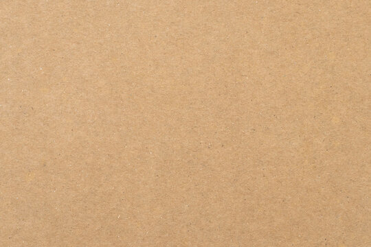 Texture of old paper, brown background. Yellow packaging, vintage dirty page. Craft sheet, natural pattern of papyrus. Carton container surface close up.
