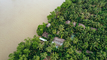 homestay hotel in the tropical jungle coastline of the brown mekong river in Ben Tre Vietnam