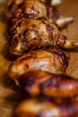 Grilled chicken legs on a metal skewer