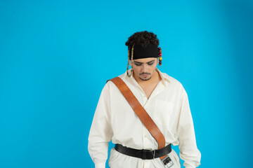 Portrait of young handsome prate stand on blue background and looking down