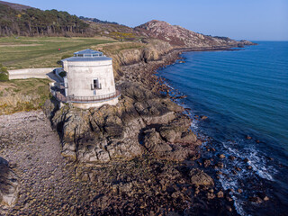 Aerial view of a martello tower hotel in Howth with the mountain in the backgroun