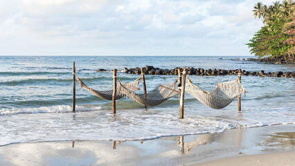empty cradle on the beach with sea in the background.