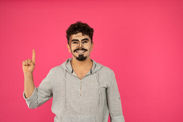 A man with pop-up makeup stands on red background and smiling