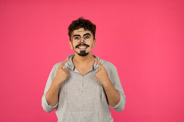 Obraz premium A man with pop-up makeup point finger ton himself and smiling