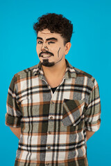 Vertical photo of young man with pop-art makeup smiling to the camera))