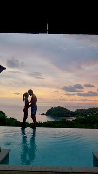 couple of men and women on a luxury vacation at a pool villa. men and women by swimming pool
