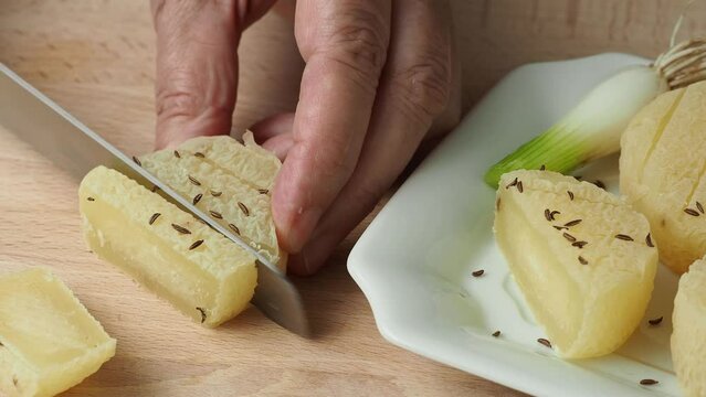 Hands cutting traditional Czech cheese. Stinky cheese. Aromatic delicacy. Dairy products.