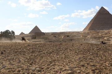 Pyramids of Giza. Scene with tourists near pyramid in Egyptian desert. Travel to the African...