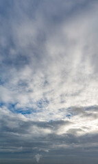 Fantastic clouds at sunrise, vertical panorama