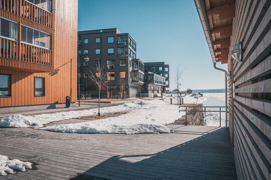 March in &Ouml;stersund, Sweden - Wooden buildings of new city quarter called Storsj&ouml; Strand during spring winter under blue sky on the waterfront to Lake Storsj&ouml;n.
