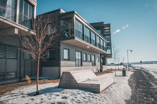 March in &Ouml;stersund, Sweden - Wooden buildings of new city quarter called Storsj&ouml; Strand during spring winter under blue sky on the waterfront to Lake Storsj&ouml;n.