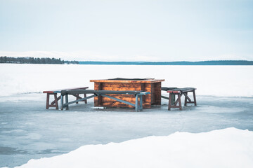 Bonfire place with wooden benches on ice skating track called 