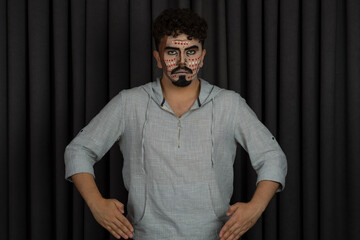 Confident young guy stand on black background and but his hands to his waist