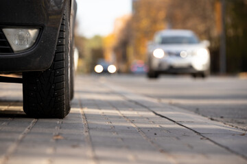 car with studded wheels in a parking lot on the side of the road