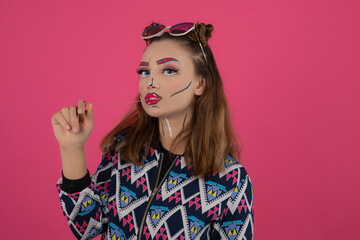 Fototapeta premium Close up portrait of young girl wearing creative makeup and looking at camera