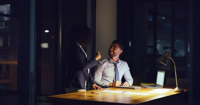 Two businesspeople give high five while working late. Colleagues celebrate after finishing paperwork or achieve success during overtime at office. Accountant or lawyer make breakthrough or deadline