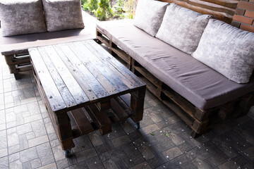 Furniture from pallets in the gazebo. Sofa and table in the barbecue lounge area