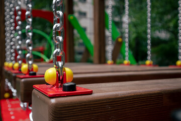 Children's wooden bridge on chains. Hanging bridge on the playground