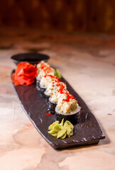 japanese dish rice rolls with cheese on a black plate