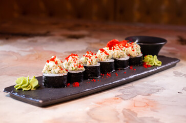 japanese dish rice rolls with cheese on a black plate