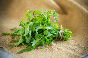 bunch of fresh juicy green arugula on burlap