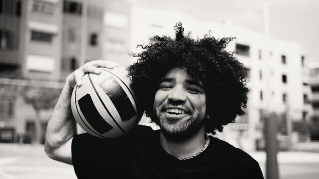 Happy man playing basketball outdoor - Urban sport lifestyle concept - Black and white editing