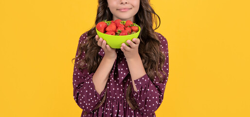 cropped view of teen girl hold strawberry bowl on yellow background