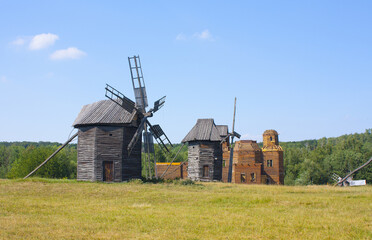 Fototapeta na wymiar Wooden mills in the museum of national architecture in Pirogovo, Ukraine