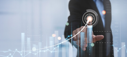 Businessman pointing on touch screen, analyzing financial data and sale report to achieve business goals with economy graph growth chart, Business analysis, finance and investment concept.