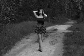 Outdoors portrait of young curly woman in black and white