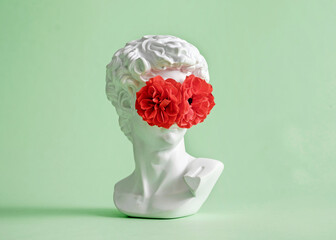 Michelangelo's David head sculpture with rose flower closed eyes and face. Minimal pastel creative...