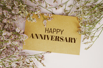Happy Anniversary text message with flower decoration blue background