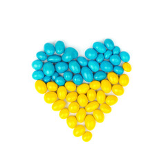 heart made of yellow and blue candy on a white background.