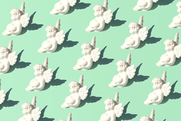 Cupid figures, creative pattern on pastel mint green background. Love and passion theme. 