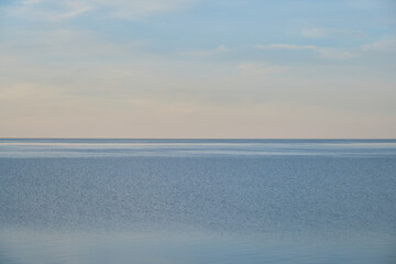 Fototapeta na wymiar Blue pond and horizon line in distance. Clear summer sky. Beautiful seascape. Lake Ilmen, Novgorod region, Russia.