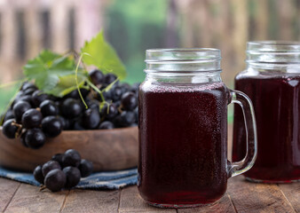Glass of grape juice with rural background