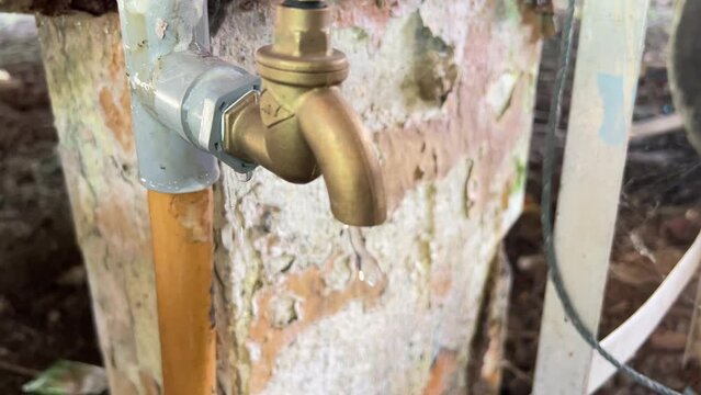 Leaking water tap closeup. Needs immediate repair due to water wastage.