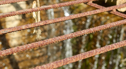 Discharge of water through an iron grate with rust.