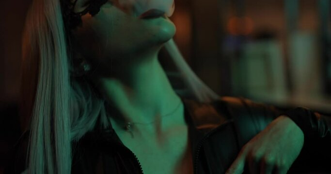 Sexy attractive frisky woman smoking hookah in the night bar