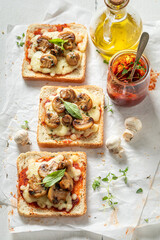 Hot and tasty toasts with mushrooms, olive oil and cheese.