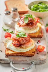 Homemade and tasty toasts with toast, bacon and eggs.
