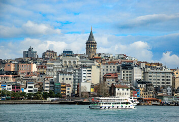 Fototapeta na wymiar Galata tower hill with building with ferry boat on Golden Horn in Istanbul