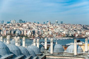 Galata tower hill with building with ferry boat on Golden Horn in Istanbul