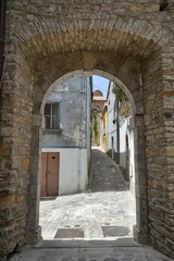 Fototapeta na wymiar A narrow street between the old houses of Pietragalla, a village in the Basilicata region, Italy.