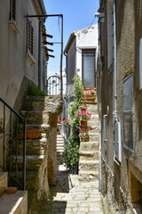 A narrow street between the old houses of Pietragalla, a village in the Basilicata region, Italy.