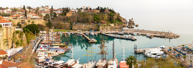 Naklejka premium Antalya Turkey, 04 01 2022: It has a mooring capacity of 100 boats right in front of the city of Antalya. The depth inside the harbor is 6-7 meters. The part to the starboard of the entrance is shall