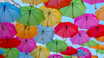 Multicolor umbrellas background. Street art summer and city tourism concept.