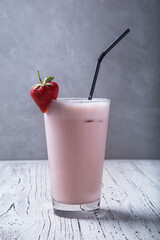 Strawberry milkshake on grey background
